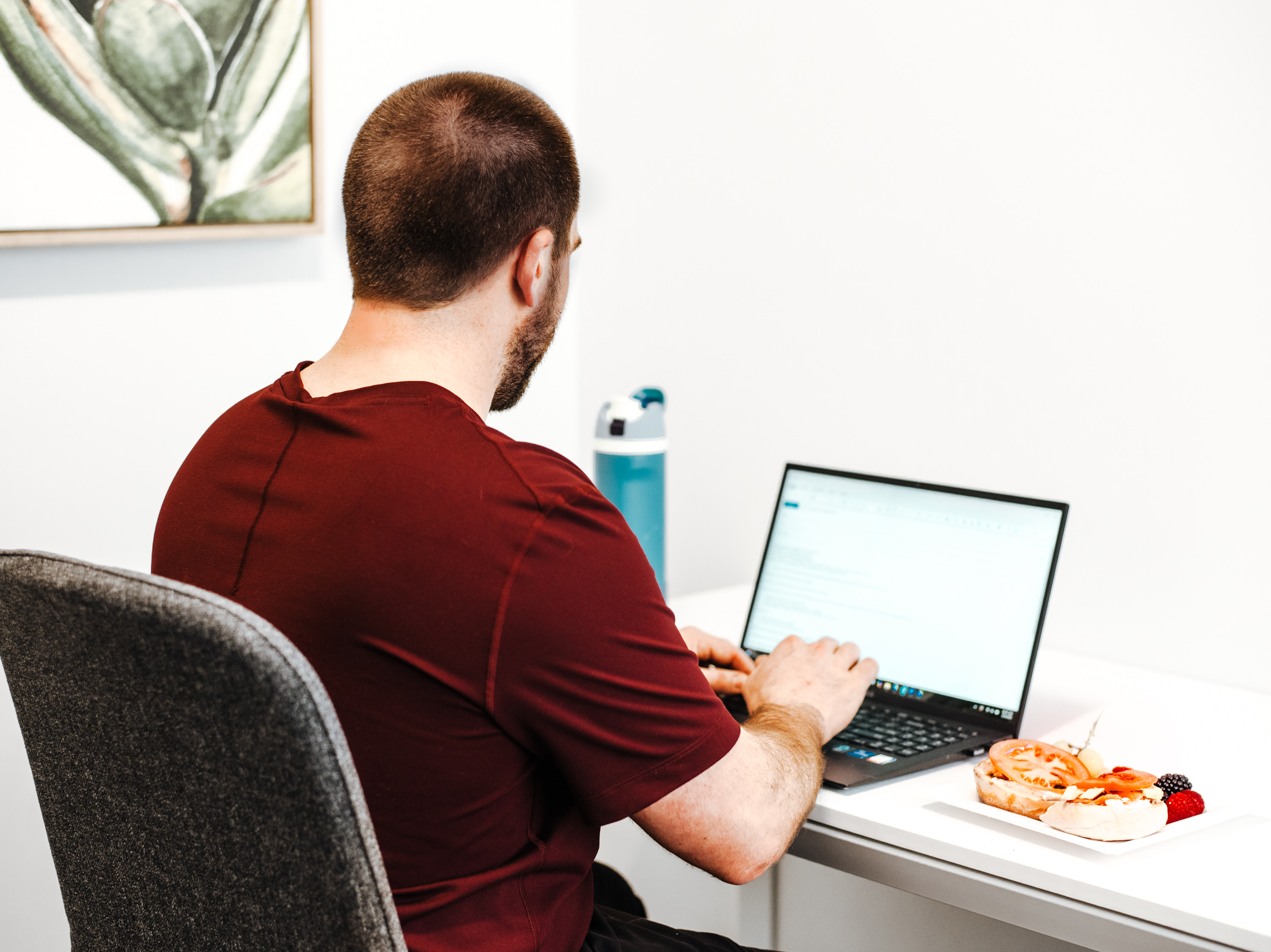 Professional working at a laptop in a quiet private office workspace at Haven Collective coworking in Columbus, Ohio.